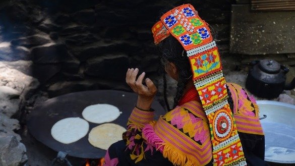 A Kalash woman bakes nan (bread) at home. [Alamgir Khan]