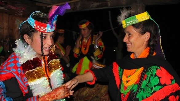 Other Kalash women are shown dancing. [Alamgir Khan]