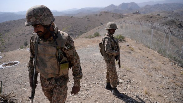 Pakistani soldiers patrol next to a newly fenced border separating North Waziristan and Afghanistan October 18. [Aamir Qureshi/AFP]