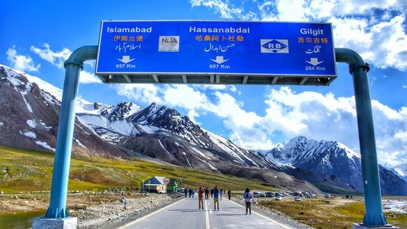 Visitors photograph Khunjerab Top, the highest point of the eponymous pass, on Karakoram Highway in Gilgit-Baltistan in September. [Alamgir Khan]