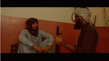 A screen shot from a video submission by Shehbaz Khan portrays a group of Pakistanis who lay down their weapons to be part of a peaceful society.