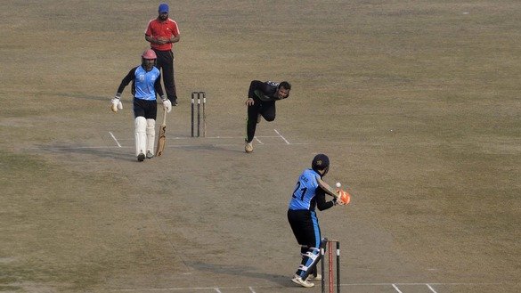 Afghan refugee players play cricket in Peshawar December 5. [Shahbaz Butt]