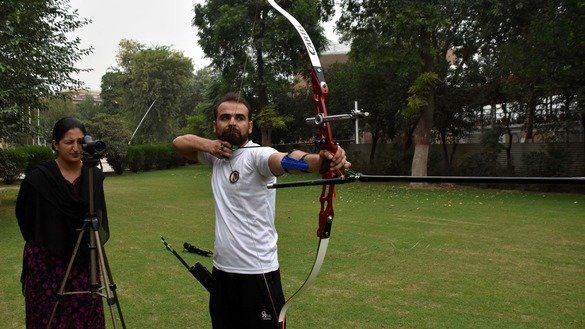 Archery trainer Sara Khan observes a student during a training session in November in Peshawar. [Muhammad Shakil]