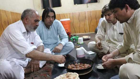 Customers at a resturant in Peshawar enjoy tikka karahi September 1. [Alamgir Khan]