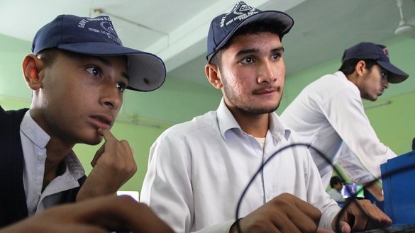 Haseeb Khan (right), an eighth-grade student at Government Shaheed Shahzad Ijaz High School Peshawar, works on a computer on November 14. Although he never touched a computer before starting the EAP, "now I can develop websites and computer games," he said. [Danish Yousafzai]