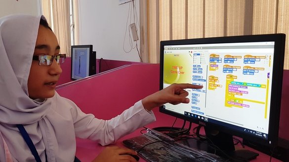 Wajeeha Khan, a seventh-grade student, explains the coding of her computer game on November 14 at Government Shaheed Shahzad Ijaz High School Peshawar. She developed a maze game in two months.[Danish Yousafzai]