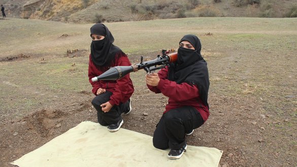 Female police commandos training in Nowshera in October learn how to use a rocket-propelled grenade launcher. [Javed Khan]