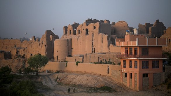 Men walk along a pathway near an old palace at Qala-e-Kohna, a historic site in Lashkargah, the capital of Helmand province, on March 27. [Wakil Kohsar/AFP]