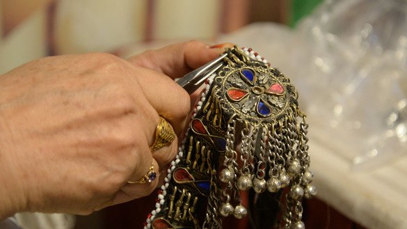 A female jeweller's hand is shown in close-up at the Hunar Mela May 9. [Shahbaz Butt]