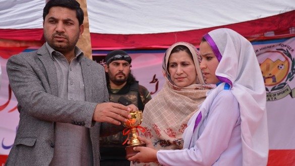 Additional Political Agent Mohmand Agency Hamid ur Rehman (left) hands out prizes to wining students during the Mohmand Sports Youth and Cultural Festival. [Alamgir Khan]