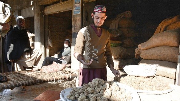 A store worker in Charsadda District in January sells gur. [Alamgir Khan]