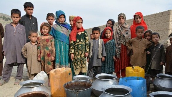 Children wait near a tube well in Baizai Tehsil, Mohmand District, in July to fill their containers with drinking water. [Alamgir Khan]