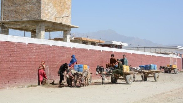 Young boys and girls carry water on donkey carts in Baizai Tehsil of Mohmand District in July. [Alamgir Khan]