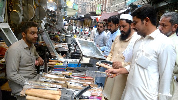 Customers purchase knives in Reeti Bazaar, Peshawar, August 11. [Shahbaz Butt]