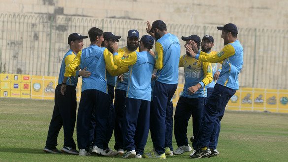 Members of the Al-Hilal Challengers celebrate the fall of a wicket during a match in Peshawar August 31. [Shahbaz Butt]