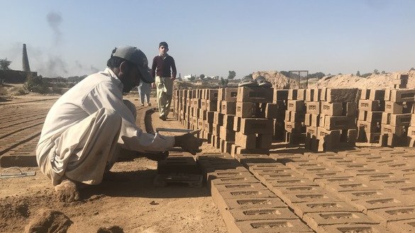 A brick kiln worker stacks bricks in Fateh Jang Tehsil, Punjab Province, December 1. [Nazar ul Islam]