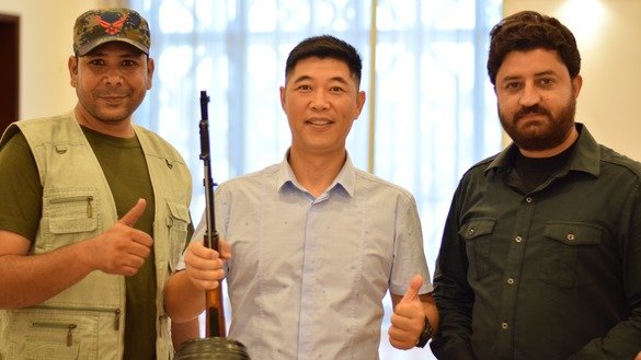 An unidentified foreign visitor to the Target and Outdoor Shooting Sports Show, held in Islamabad last September 28-30, poses with the owners of a stall at the show. [Pakistan Hunting and Sporting Arms Development Co.]