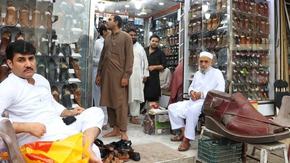Customers buy Peshawari chappal ahead of Eid ul Fitr in Peshawar May 24. [Alamgir Khan]