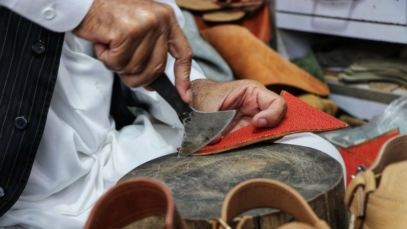 A shoemaker in Peshawar makes traditional Peshawari chappal on May 24. [Alamgir Khan]