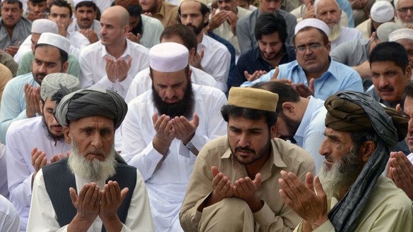 Peshawar residents pray on June 4. [Shahbaz Butt]