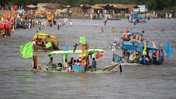 Khyber Pakhtunkhwa residents celebrate Eid by riding boats in Charsadda District on June 4. [Shahbaz Butt]