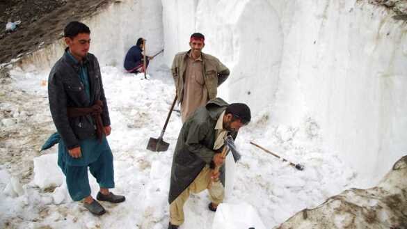 Chitral residents break off glacier ice on July 1. [Alamgir Khan]