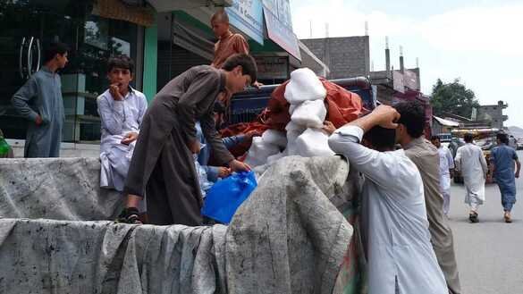 Chitral residents sell glacier ice July 1 in the Chitral bazaar. [Alamgir Khan]
