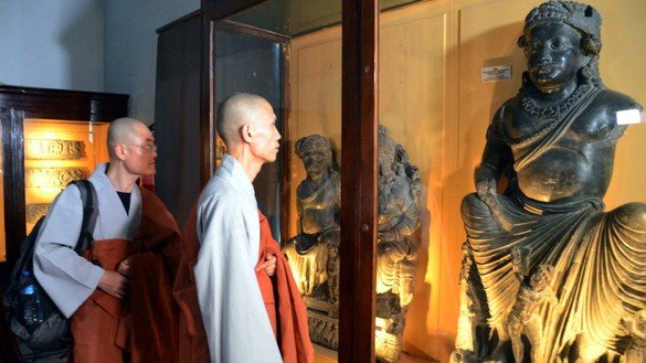 Buddhist monks from South Korea visit a section of the Peshawar Museum during their four-day long heritage tour of Khyber Pakhtunkhwa. [Adeel Saeed]