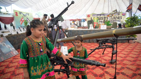 Children look at different guns at Karnal Sher Khan Army Stadium in Peshawar September 6. [Shahbaz Butt]