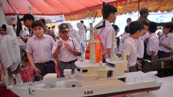 Students look at a ship model at a security exhibition in Peshawar September 6. [Shahbaz Butt]