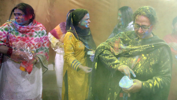Women throw colours on each other during Holi celebrations in Peshawar March 10. [Shahbaz Butt]