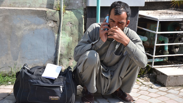 A Pakistani expatriate March 15 sits outside the Pakistan International Airlines ticket office in Peshawar Saddar trying to reschedule his flight to Saudi Arabia. Pakistan ordered all international flights to use only three airports -- Karachi, Lahore and Islamabad -- March 15 to 31 in response to the coronavirus pandemic. [Shahbaz Butt]