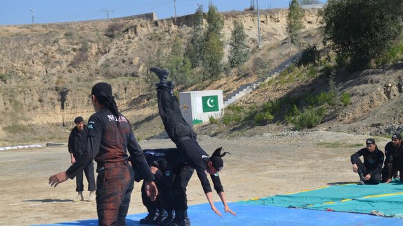 Police commandos in Nowshera in October exhibit their skills from physical training. [Javed Khan]
