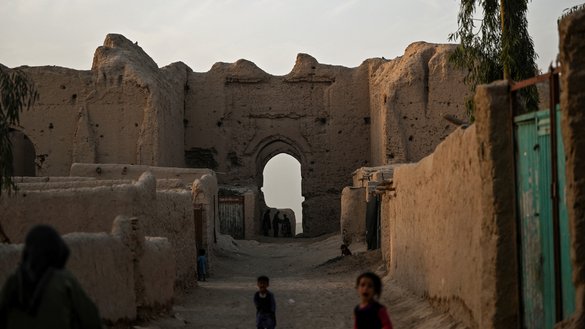 Internally displaced Afghan children walk inside the ruins of a palace where they live with their families at the historic site of Qala-e-Kohna in Lashkargah, Helmand province, on March 27. [Wakil Kohsar/AFP]