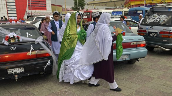 An Afghan couple leaves the wedding hall after a mass marriage ceremony in Kabul on June 13. [Sahel Arman/AFP]